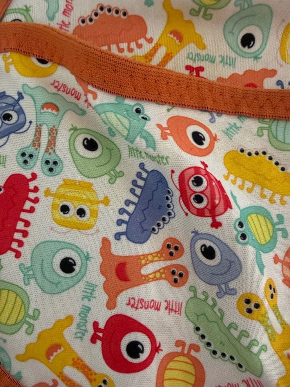 Kids Orange Trim Baby Bib with Colorful Monster Print